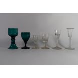 Two 18th century air-twist wine glasses together with two further green coloured wine glasses plus