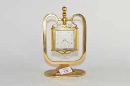 Brass model of a clock together with a barometer and hygrometer, German manufacture, in brass frame
