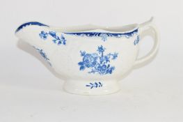 Lowestoft porcelain sauce boat decorated in blue and white with floral prints