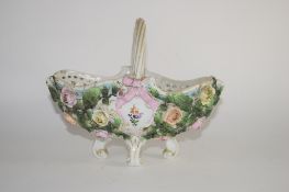 Continental porcelain flower basket on four scroll feet, the sides decorated with flower heads in