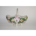 Continental porcelain flower basket on four scroll feet, the sides decorated with flower heads in