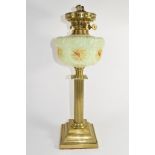 Oil lamp with glass reservoir above a Corinthian column brass base