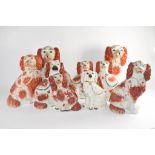 Group of nine Staffordshire dogs all decorated with sponged red decoration in typical fashion (9)