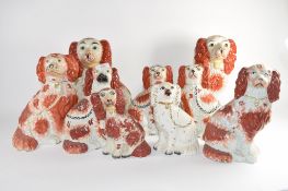 Group of nine Staffordshire dogs all decorated with sponged red decoration in typical fashion (9)