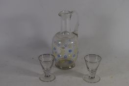 EWER WITH A PAINTED FLORAL DESIGN AND TWO SMALL SHOT GLASSES