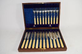 BOXED SET OF FISH KNIVES AND FORKS WITH BONE HANDLES AND SILVER FERRULES AND CHASED SILVER