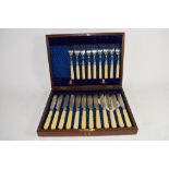 BOXED SET OF FISH KNIVES AND FORKS WITH BONE HANDLES AND SILVER FERRULES AND CHASED SILVER