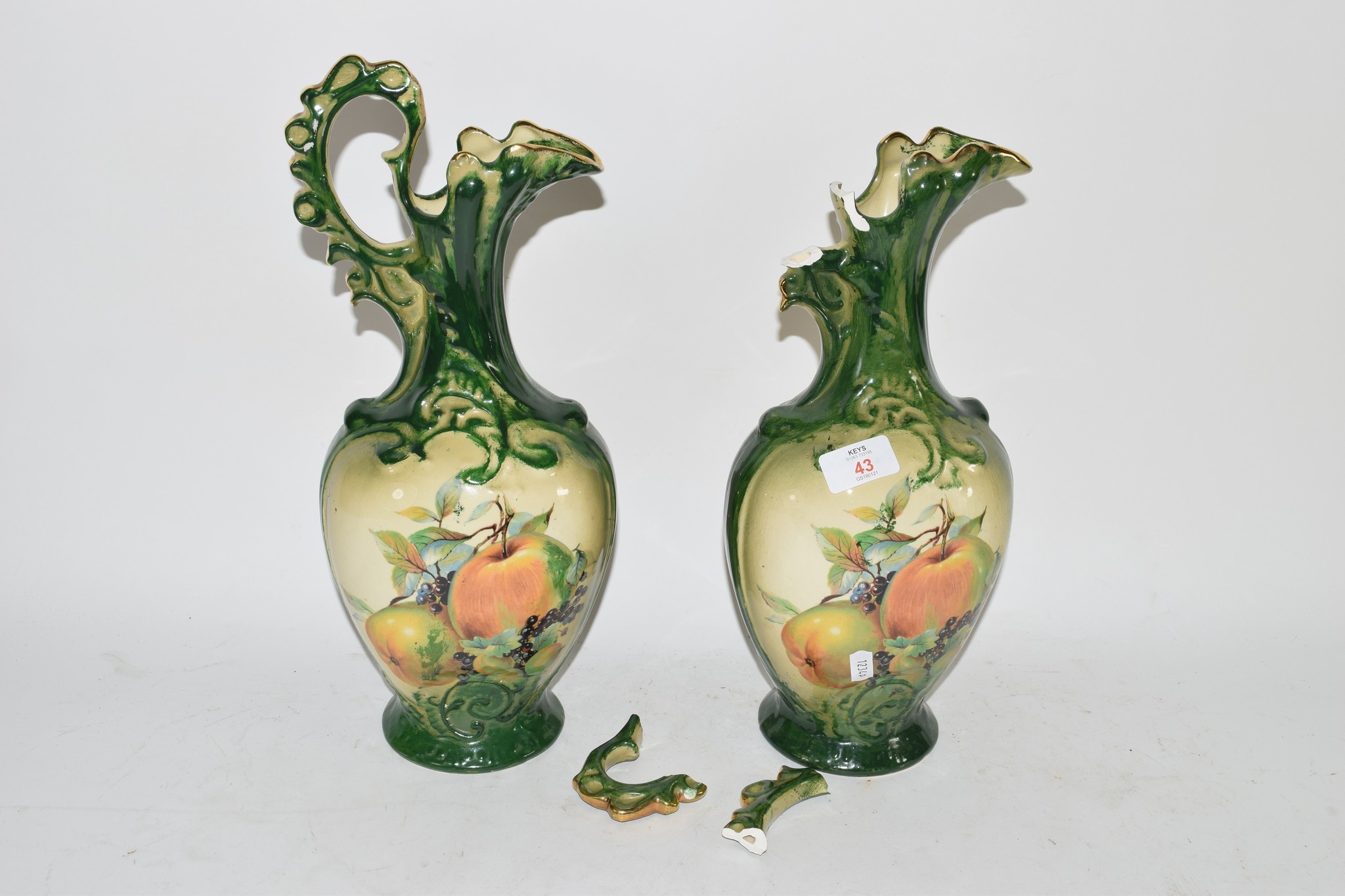 PAIR OF POTTERY EWERS, GREEN GLAZED, WITH FRUIT DECORATION