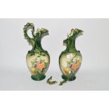 PAIR OF POTTERY EWERS, GREEN GLAZED, WITH FRUIT DECORATION
