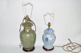 LAMP WITH ORIENTAL BLUE POTTERY DESIGN TOGETHER WITH A GREEN GLAZED POTTERY LAMP (2)