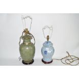 LAMP WITH ORIENTAL BLUE POTTERY DESIGN TOGETHER WITH A GREEN GLAZED POTTERY LAMP (2)