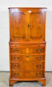 SMALL REPRODUCTION COCKTAIL CABINET WITH FOUR DRAWERS AND BRUSHING SLIDE BENEATH AND CROSS-BANDED