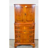 SMALL REPRODUCTION COCKTAIL CABINET WITH FOUR DRAWERS AND BRUSHING SLIDE BENEATH AND CROSS-BANDED