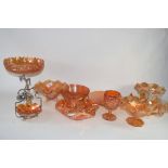 MANDARIN COLOURED CARNIVAL GLASS WARES INCLUDING A PEACOCK PLATE, STAR SHAPED BOWL, A FRUIT AND