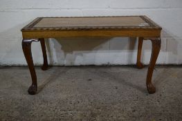 REPRODUCTION OAK SMALL COFFEE TABLE ON BALL AND CLAW FEET WITH CARVED FLORAL DESIGN TO TOP, LENGTH