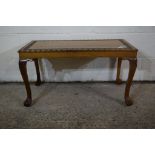 REPRODUCTION OAK SMALL COFFEE TABLE ON BALL AND CLAW FEET WITH CARVED FLORAL DESIGN TO TOP, LENGTH