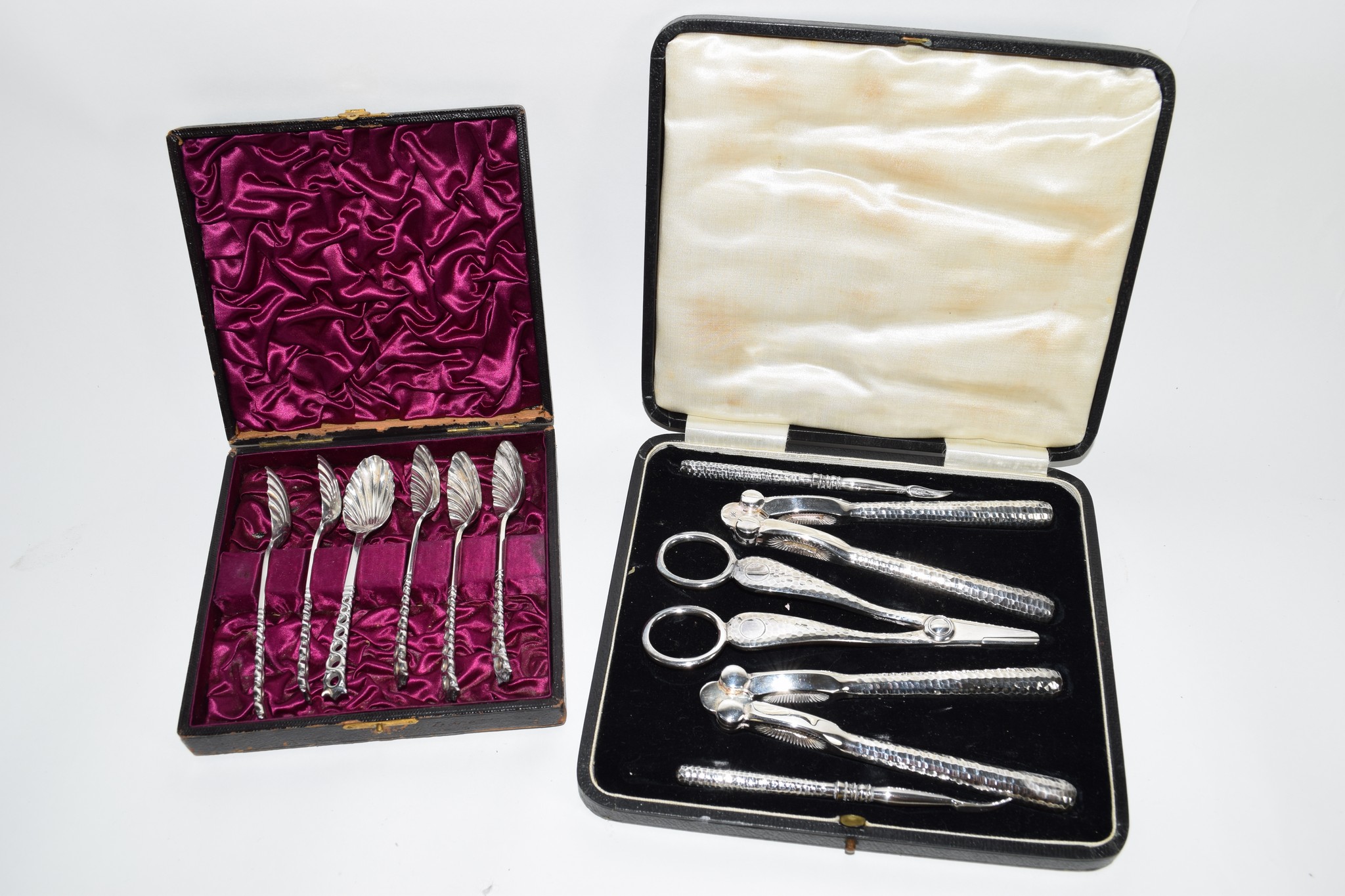 BOX OF SILVER PLATED TEA SPOONS TOGETHER WITH BOX CONTAINING SILVER METAL NUTCRACKERS AND GRAPE