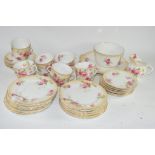 PART TEA SET BY ROYAL DOULTON WITH A FLORAL DESIGN COMPRISING TWELVE CUPS, SAUCERS, MILK JUG, SIDE