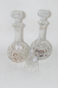 TWO TALL CUT GLASS DECANTERS AND STOPPERS, TOGETHER WITH A CUT GLASS BELL