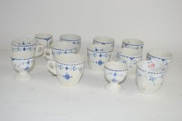 CUPS AND SAUCERS WITH BLUE AND WHITE DESIGN