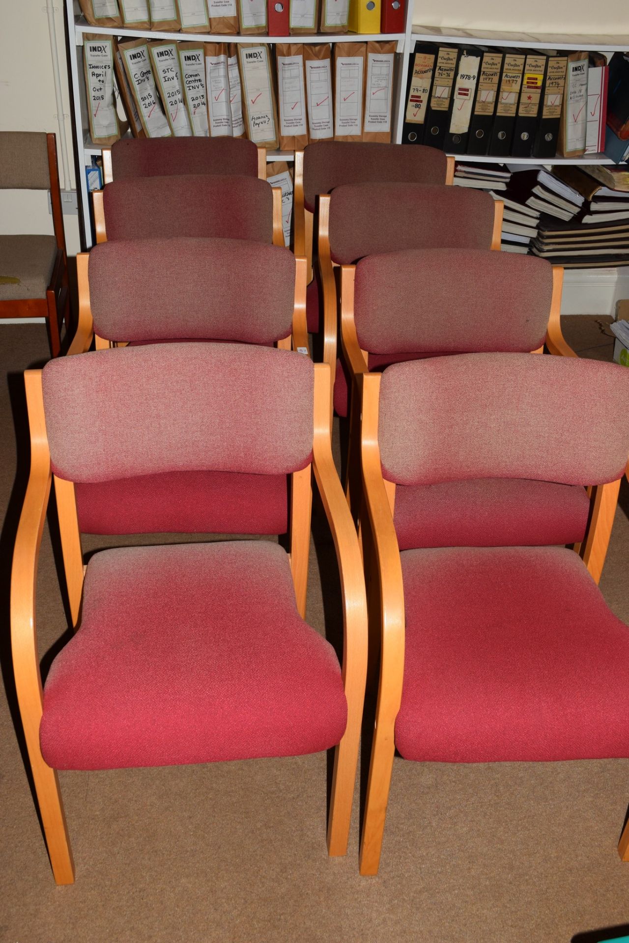 Eight beechwood framed office chairs, upholstered in faded pink fabric