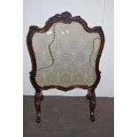 HEAVILY CARVED VICTORIAN FIRE SCREEN RAISED ON CHEVAL LEGS, WITH FLORAL DECORATED INSET, WIDTH