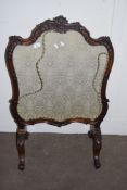 HEAVILY CARVED VICTORIAN FIRE SCREEN RAISED ON CHEVAL LEGS, WITH FLORAL DECORATED INSET, WIDTH