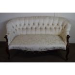 19TH CENTURY MAHOGANY FRAMED BUTTON BACK SOFA IN THE ROCOCO STYLE, RAISED ON CARVED LEGS OVER