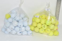 TWO PLASTIC BAGS CONTAINING GOLF BALLS