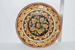 CONTINENTAL POTTERY CHARGER WITH INCISED DECORATION OF FLOWERS