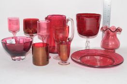 RED COLOURED CRANBERRY TYPE GLASS WARES INCLUDING JUG, VASE, BEAKERS WITH ENGRAVED DESIGN