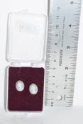 PLASTIC BOX CONTAINING PAIR OF EARRINGS WITH CAMEO STYLE DECORATION