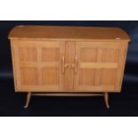 Mid-century light oak Ercol sideboard, two doors with central sliding catch, Ercol stamp to inside