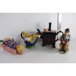 THREE VARIOUS NOVELTY TEA POTS INCLUDING A WOOD CHICKEN, A SOUTH WEST CERAMICS KITCHEN STOVE AND A