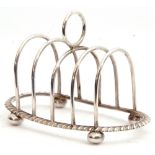 Edward VIII silver toast rack of oval form, four hoop divisions with central circular carrying