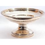 George V silver pedestal fruit bowl with a pierced geometric section, gadrooned rims, standing on