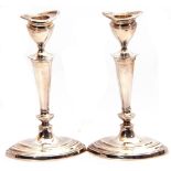 Pair of silver candlesticks of oval form, detachable reeded sconces, tapering knopped stems on a