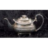 George IV silver tea pot of oval form having a reeded body with applied scroll and shell rim, a