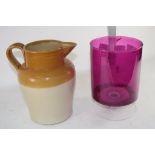 PINK COLOURED GLASS CYLINDRICAL VASE AND A TWO-TONE BUFF CERAMIC JUG