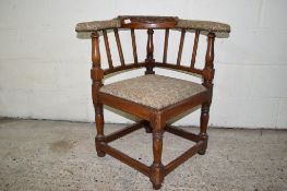 JOINTED OAK CORNER ARMCHAIR WITH UPHOLSTERED ARMS AND CARVED DECORATION TO BACK, TOTAL WIDTH