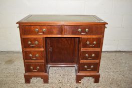 REPRODUCTION SMALL MAHOGANY TWIN PEDESTAL DESK WITH GILT GREEN TOOLED LEATHER INSERT, TWO FRIEZE