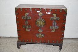 ORIENTAL RED STAINED AND BRASS MOUNTED CHEST, TWO SMALL DOORS TO FRONT ENCLOSING A VOID INTERIOR