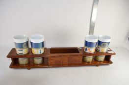 WOODEN RACK CONTAINING POTTERY MUGS