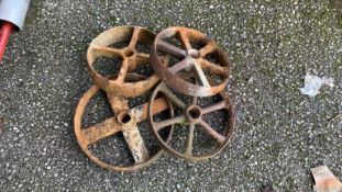 Four various cast iron wheels