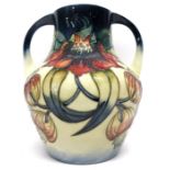 Large Moorcroft modern two-handled vase with a tube lined design in the Anna Lily pattern by