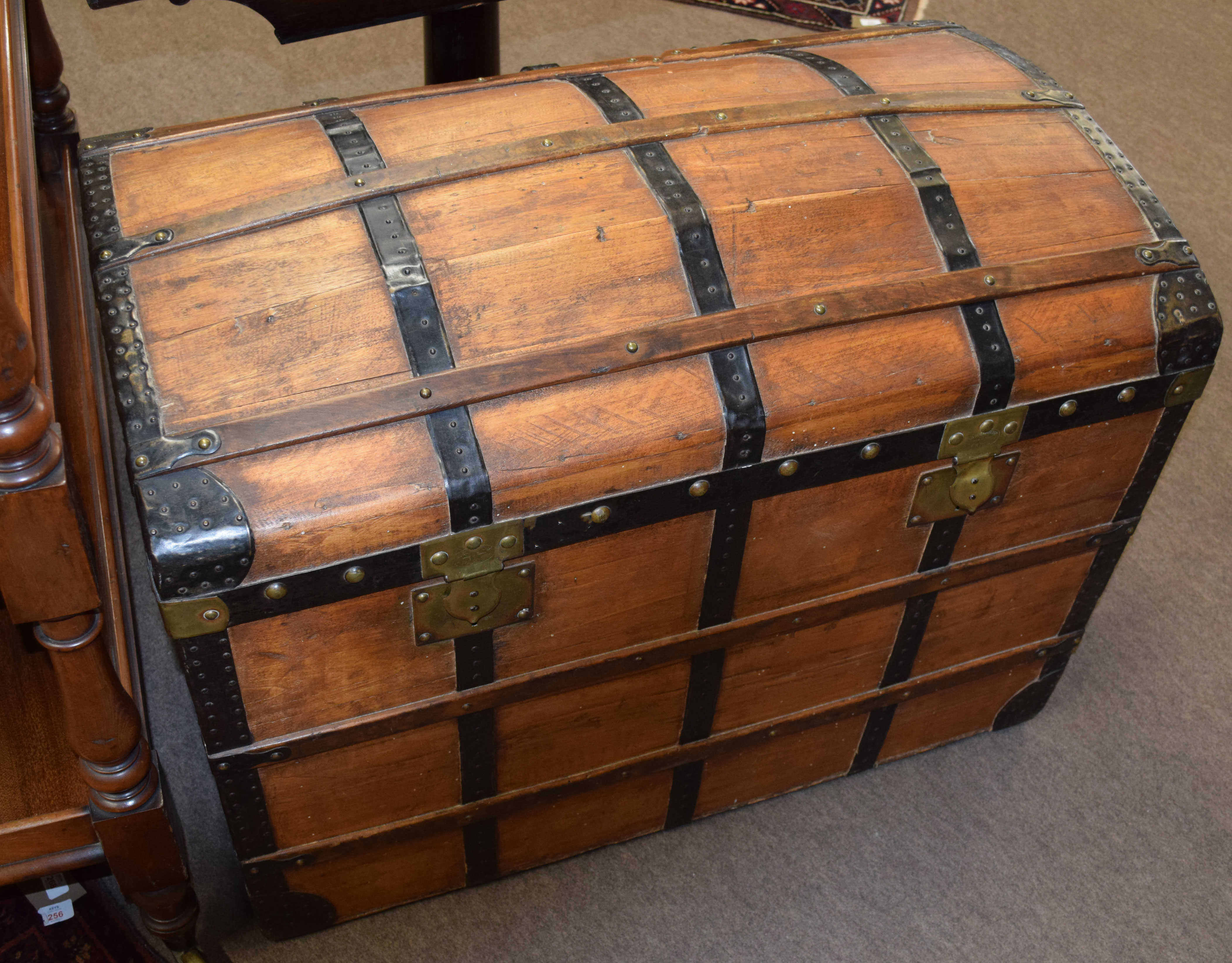 Late 19th century stained wood travelling trunk with metal and wood lath mounts to the domed lid and
