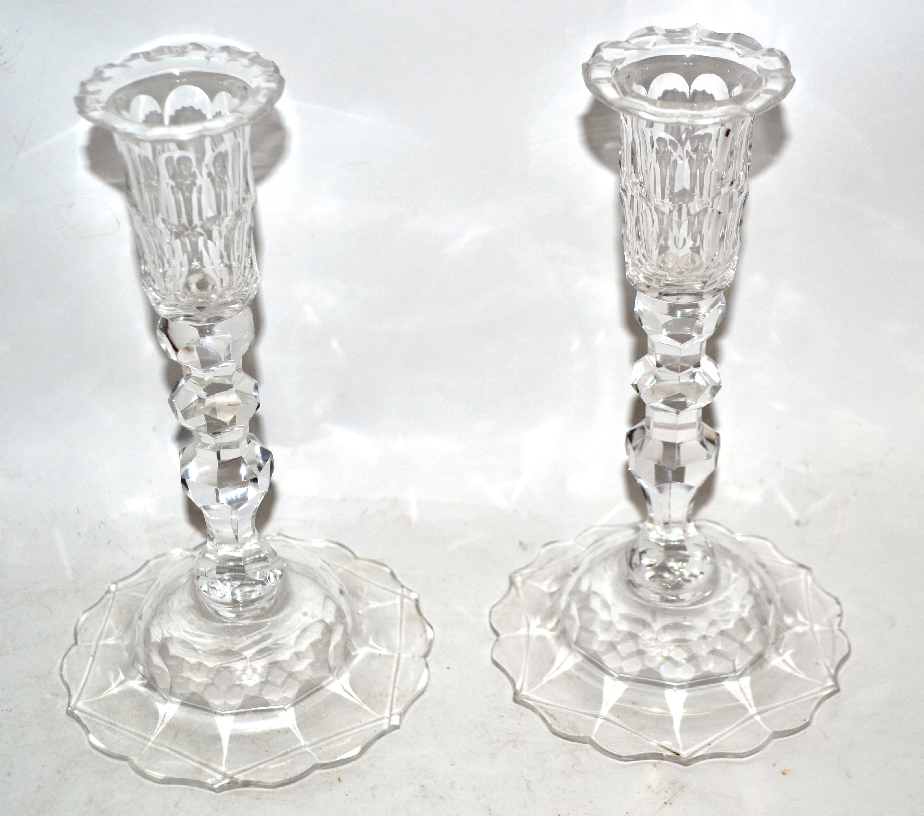 Pair of glass candlesticks, 19th century, with knopped faceted stems on a domed base, 23cm high