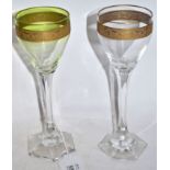 Pair of wine glasses, probably Moser, with green tint and a gilt engraved band above a faceted