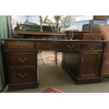 Late 19th/early 20th century mahogany partner's desk with gilt tooled red inset, the two pedestals