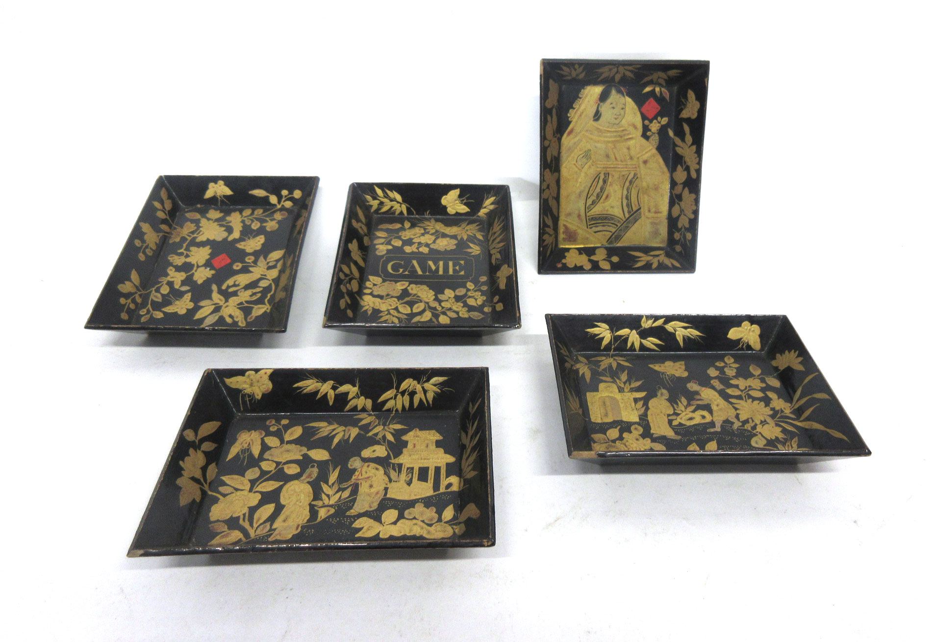 Group of five small Oriental trays with lacquered decoration on a black ground (5)